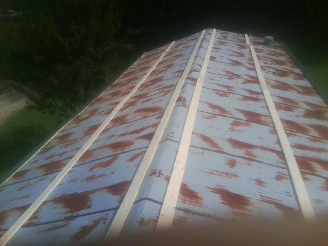 Rusted metal roof panels with new wood purlins before replacement — Storm Damage Roof Repair in Highland Lakes by Roofing Brothers